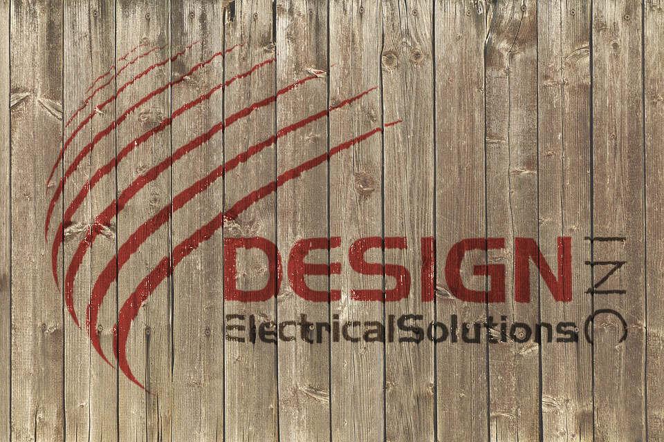 Design Electrical Solutions Inc logo on a wood background