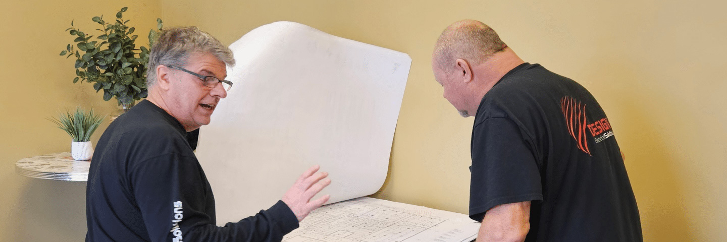 Design ES owner and employee reviewing blueprints